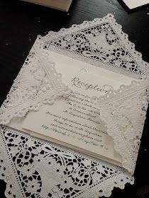 the wedding stationery is laid out on top of the lace doily and ready to be cut