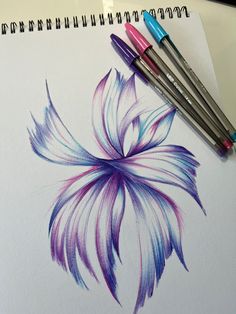 three watercolor pencils are next to a drawing of a purple and blue flower