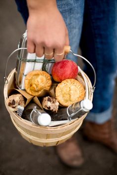 a person holding a basket filled with pastries