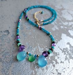 This is s7ch a vibrant and fun gemstone necklace It shines so beautifully in the sunlight and adds character to any outfit! It was made with genuine gemstones, I put together beautiful natural and the most beautiful Apatite, Amethyst, Chrysoprase, Spinel and Chalcedony gemstones and combined them into this unique and eye-catching creation! Treat yourself to some optimism Material: gemstones, gold filled clasp and chain. Dimensions : the lenght of the necklace is about 16.7 inches. It that can be Multi Colour Gemstone Necklace, Ocean Bracelet, Round Bead Necklace, Rainbow Gemstones, Large Necklace, Green Necklace, Animal Jewelry, Gemstone Colors, Gemstone Necklace