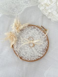 two wedding rings sitting on top of a lace doily