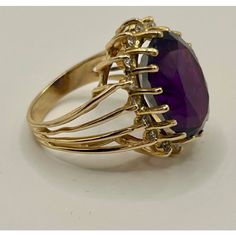 This is part of Chairish’s Fine Jewelry assortment.  14k yellow gold cocktail ring featuring a deep purple/red/blue oval amethyst, encircled by 16 small diamonds.  Ring Size: 6 in. Stone: 16.42 x 12.40 x 8.7 mm Ring Weight: 6.7 grams  If you would like more information, please contact me via email, mrboult@gmail.com. Antique Appraisal, Yellow Gold Cocktail Ring, Amethyst And Diamond Ring, Gold Cocktail Ring, Gold Cocktail, Diamonds Ring, Diamond Cocktail Rings, Ring Ring, Cocktail Ring