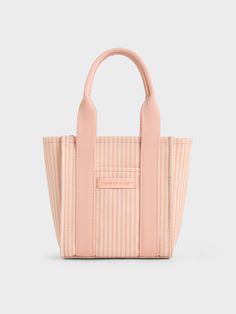 This product is made with at least 20% sustainable materials by weight. CHARLES & KEITH uses recycled, degradable, organic, and water-based materials in our eco-conscious collection.The new season brings back the Kay in brand-new sizes and colours -- like this striped version in eye-catching pink. This mini bag is perfect for casual days out and vacations -- compact and functional, it makes for a great travel companion, and will fit into your carry-on suitcases without taking up much space. It w Eco-friendly Shopping Bucket Bag With Removable Pouch, Eco-friendly Double Handle Bucket Bag, Eco-friendly Spring Bag With Top Carry Handle, Eco-friendly Recyclable Shoulder Bag With Double Handle, Eco-friendly Double Handle Bucket Bag For Shopping, Casual Recyclable Rectangular Bags, Functional Bags For Daily Use In Spring, Eco-friendly Spring Bags With Leather Handles, Eco-friendly Bags With Leather Handles For Spring