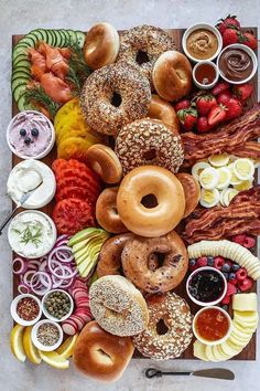 an assortment of doughnuts and fruit on a platter