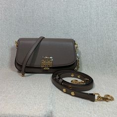 Brand New Never Been Carried Portobello Britten Cross Body Bag/Shoulder Bag/Clutch By Tory Burch This Bag Is Made Of Taupe Genuine Leather Chain Strap And Adjustable Leather Strap Are Both Removable, So You Can Use The Bag As A Clutch Or Cross Body Bag Or Shoulder Bag. Dimensions: 8.5" Widest X 4.75" Tall Center X 2.5" Deep. Magnetic Button And Flap Closure Interior: Single Compartment With 1 Zipper Pocket And One Slip Pocket Fabric Lining. Gold Tone Metalware. Outlet Item Doesn't Come With Dust Classic Gray Bags With Gold-tone Hardware, Designer Gray Shoulder Bag With Gold-tone Hardware, Gray Evening Bags With Gold-tone Hardware, Convertible Bags, Tory Burch Bag, Portobello, Leather Chain, Cross Body Bag, Bag Shoulder