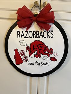 a red and black sign that says razorbacks who's pig scale?