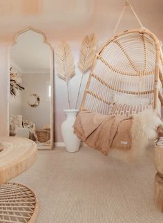 a hammock hanging from the ceiling in a room with mirrors and other furniture