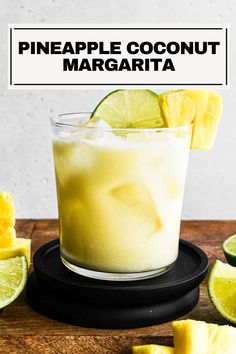 a pineapple coconut margarita in a glass with limes around it and the text overlay reads pineapple coconut margarita