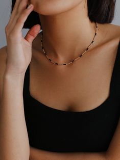 Experience the exquisite beauty of our handcrafted Black Spinel Gold Bean Mini Bead Necklace. Each element is carefully handcrafted to create a refined, elegant look. Add a touch of sophistication to any outfit with this versatile and glamorous necklace. Metal: 18ct Recycled Gold Plated On Brass Gemstone:Black Spinel Pearl: Freshwater Pearl 2.5mm Length: 400-450mm Weight: 5g