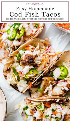 three homemade fish tacos with cole slaw and jalapenos on the side