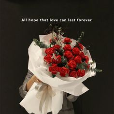 a woman holding a bouquet of red roses with the words, all hope that love can last forever