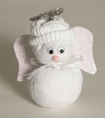 a small white angel ornament sitting on top of a table