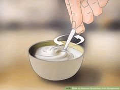 a person stirring something in a bowl with a spoon