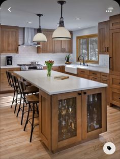 a large kitchen with wooden cabinets and white counter tops