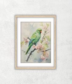 a green bird sitting on top of a tree branch with pink flowers in front of it