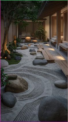 a japanese garden with rocks and benches in the center, lit up by lights at night