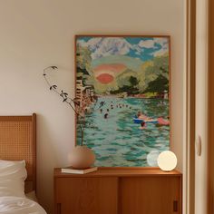 a painting is hanging on the wall above a bed