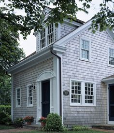 an old house with white trim and windows