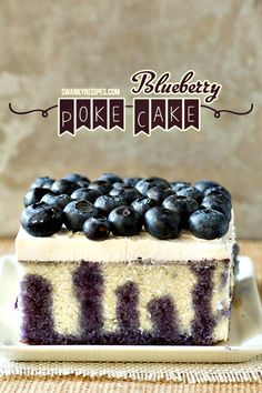 a blueberry poke cake on a plate with the title above it that reads, blueberry poke cake