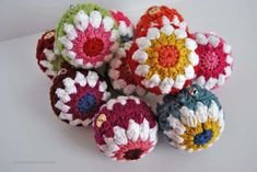 several crocheted balls are sitting on a table