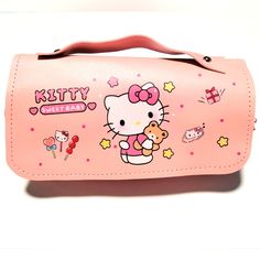 a pink hello kitty purse is shown on a white surface