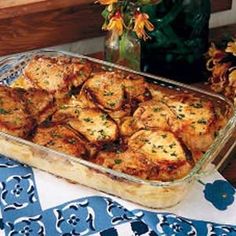 a casserole dish on a table with flowers in the background