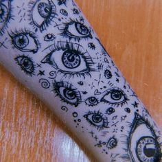 an eyeball tattoo on someone's arm that is drawn with black and white ink