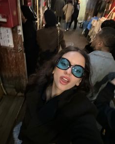 a woman with sunglasses on taking a selfie