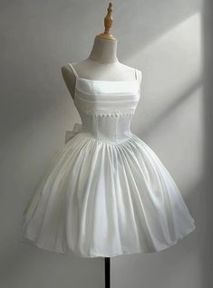 a white dress on a mannequin stand