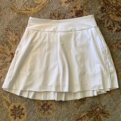 Nwot Kyodan Tennis / Golf Pleated White Skirt With Built In Shorts, Xs White Stretch Tiered Skirt, White Skirted Skirt With Built-in Shorts, White Stretch Tiered Tennis Skirt, White Tiered Stretch Tennis Skirt, White Pleated Tiered Tennis Skirt, Fitted White Tiered Skort, White Skirted Bottoms With Built-in Shorts, White Stretch Lined Skort, White Stretch Skort With Lined Skirt