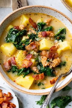 two bowls of soup with potatoes, spinach and bacon