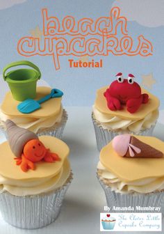 three cupcakes are decorated with fondant and icing, one is crab, the other has an ice cream cone