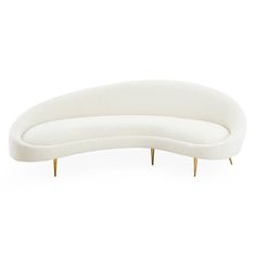 a curved white couch with gold legs