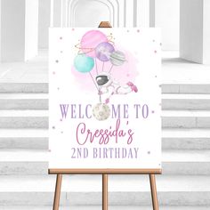 a welcome sign with balloons on it in front of some white steps and stairs,