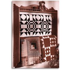 an old fashioned book shelf with quilts on it