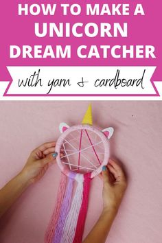 someone is making a unicorn dream catcher with yarn and cardboard