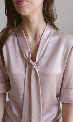 A forever elegant classic. This versatile bow blouse is a dynamic beauty: think Madame President to romantic rendezvous – she can do it all. Wear the neck tie on, off, half-way, or tie it into a bow for a look of class and sass. Removable neck bow to switch up your look. A classy v-neck cut. Concealed button placket for an elegant finish. 100% MULBERRY CHARMEUSE SILK – Washable Elegant V-neck Top With Bow, Formal Silk Tie-neck Blouse, Formal Silk Tie Neck Blouse, Silk Tie Neck Blouse For Formal Occasions, Elegant Silk Tops With Bow Detail, Elegant Silk Tops With Bow, Elegant Spring Tie Neck Blouse, Elegant Silk Tie Neck Top, Feminine Silk Tie Neck Blouse