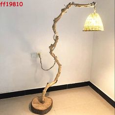 a lamp that is sitting on top of a wooden stand in the corner of a room