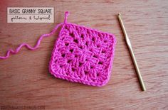 a crocheted square with a knitting needle next to it