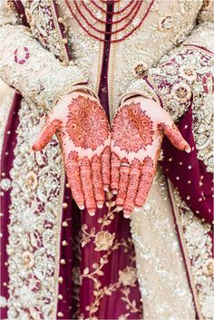 the bride's hands are decorated with hennap