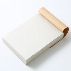 an empty white box with a roll of paper on it's side and a wooden handle