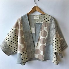 a polka dot jacket hanging on a hanger