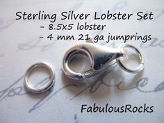 two pairs of silver lobster clasps sitting on top of a piece of paper next to each other