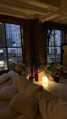 NYC aesthetic sun set living room rich old money couch light lamp house home apartment building Small Boston Studio Apartment, Dream Home Aesthetic Cozy, Nyc Flat Aesthetic, Rustic New York Apartment, New York City Appartement, English Basement Apartment, Wfh Office Setup Ideas, Downtown Apartment Living Room, Oregon Apartment Aesthetic