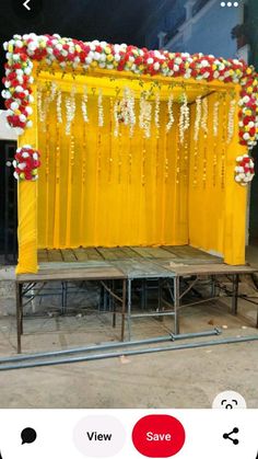 the stage is decorated with flowers and garlands