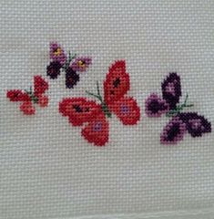 cross stitch butterflies on white fabric