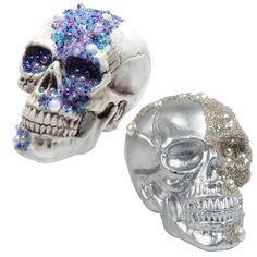 two silver and blue skulls with pearls on their heads, one has a skull in the middle