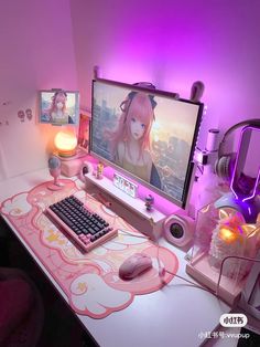 a computer desk with a keyboard, mouse and monitor on it in front of a purple light