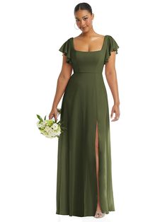 a woman in a green dress holding a bouquet