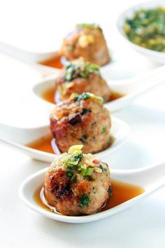 three small white bowls filled with food on top of a table